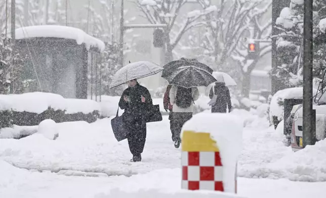 People walk in a snow in Kanazawa, Ishikawa prefecture, Japan, on Jan. 23, 2026. (Kazushi Kurihara/Kyodo News via AP)