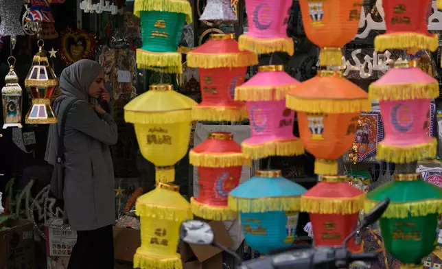 A woman shops for decorations in preparation for the upcoming Muslim holy month of Ramadan at a store in Beirut, Lebanon, Monday, Feb. 16, 2026. (AP Photo/Bilal Hussein)