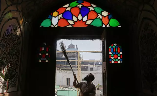 A worker cleans an area of the historic Mahabat Khan mosque in preparation for the upcoming Muslim fasting month of Ramadan, in Peshawar, Pakistan, Monday, Feb. 16, 2026. (AP Photo/Muhammad Sajjad)