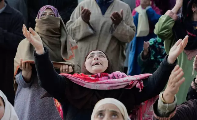 FILE - Muslim devotees pray as the head priest displays a holy relic believed to be a hair from the beard of the Prophet Muhammad during special prayers at Hazratbal shrine in Srinagar, Indian controlled Kashmir, SMarch 22, 2025 (AP Photo/Mukhtar Khan)