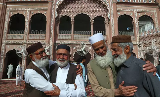 FILE - Muslims share Eid al-Fitr greeting after attending Eid prayer, marking the end of the Muslim's holy fasting month of Ramadan, at the historical Sunehri Mosque, in Peshawar, Pakistan, March 31, 2025. (AP Photo/Muhammad Sajjad, File)