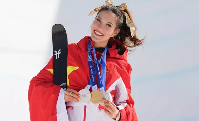 Gold medalist China's Eileen Gu poses with her medals after winning the women's freestyle skiing halfpipe final at the 2026 Winter Olympics, in Livigno, Italy, Sunday, Feb. 22, 2026. (AP Photo/Abbie Parr)
