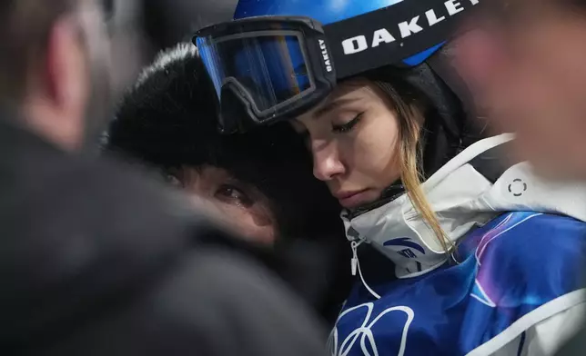 China's Eileen Gu, right, reacts alongside her mother, Yan Gu, after Canada's Cassie Sharpe crashed during the women's freestyle skiing halfpipe qualifications at the 2026 Winter Olympics, in Livigno, Italy, Thursday, Feb. 19, 2026. (AP Photo/Lindsey Wasson)