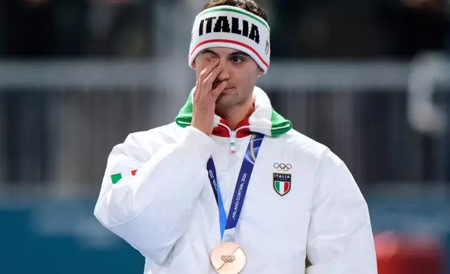 Riccardo Lorello of Italy reacts after winning the bronze medal on the men's 5,000 meters speedskating race at the 2026 Winter Olympics, in Milan, Italy, Sunday, Feb. 8, 2026. (AP Photo/Luca Bruno)