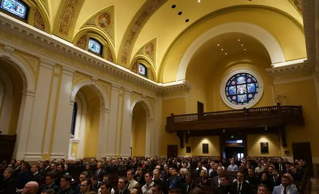 Seminarians, members of the University of St. Thomas and school principals participate in a Mass in solidarity with migrants celebrated by three Catholic cardinals and the Twin Cities' archbishop at the Chapel of St. Thomas Aquinas in St. Paul, Minn., on Friday, Feb. 27, 2026 (AP Photo/Giovanna Dell'Orto)