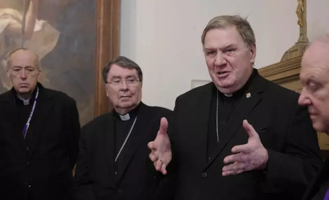 Cardinals Robert McElroy, Christophe Pierre, Joseph Tobin and Archbishop Bernard Hebda, and speak to reporters after a mass in solidarity with migrants at the Chapel of St. Thomas Aquinas on Friday, Feb. 27, 2026 in St. Paul, Minn. (AP Photo/Mark Vancleave)