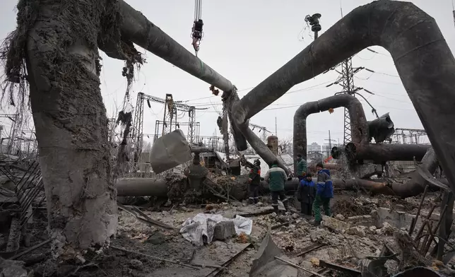 Workers clean up damage at Darnytsia Thermal Power Plant after a Russian attack in Kyiv, Ukraine, Wednesday, Feb. 4, 2026. (AP Photo/Sergei Grits)