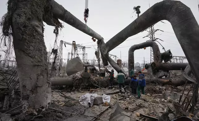 Workers clean up damage at Darnytsia Thermal Power Plant after a Russian attack in Kyiv, Ukraine, Wednesday, Feb. 4, 2026. (AP Photo/Sergei Grits)