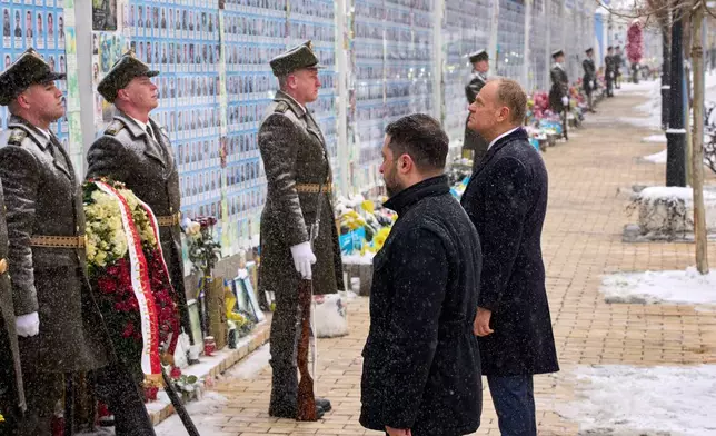 Poland's Prime Minister Donald Tusk, right, and Ukrainian President Volodymyr Zelenskyy attend a commemorative ceremony at the Memorial Wall of Fallen Defenders of Ukraine in Kyiv, Ukraine, Thursday, Feb. 5, 2026. (AP Photo/Efrem Lukatsky)