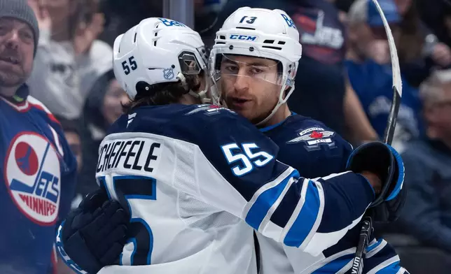 Winnipeg Jets' Gabriel Vilardi (13) celebrates his goal against the Vancouver Canucks with Mark Scheifele (55) during the second period of an NHL hockey game in Vancouver, B.C., on Wednesday, Feb. 25, 2026. (Ethan Cairns/The Canadian Press via AP)