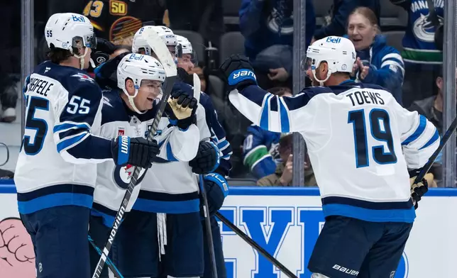 Winnipeg Jets' Cole Perfetti (91) celebrates his winning goal against the Vancouver Canucks during an overtime NHL hockey game in Vancouver, B.C., on Wednesday, Feb. 25, 2026. (Ethan Cairns/The Canadian Press via AP)