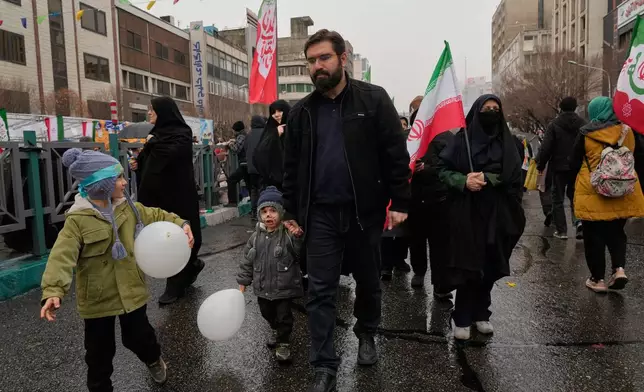 People attend a state-organised rally in Tehran, Iran, Wednesday, Feb. 4, 2026, celebrating the birthday of Imam Mahdi, or "Hidden Imam," a 9th-century saint whom Shiite Muslims believe will return at the end of time as a universal reformer to end tyranny and promote justice. (AP Photo/Vahid Salemi)