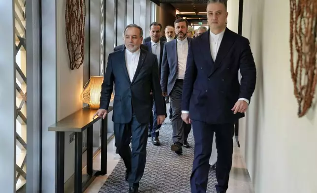In this photo released by the Iranian Foreign Ministry, Iranian Foreign Minister Abbas Araghchi, left, heads to venue for talks between Iran and the U.S., in Muscat, Oman, Friday, Feb. 6, 2026. (Iranian Foreign Ministry via AP)