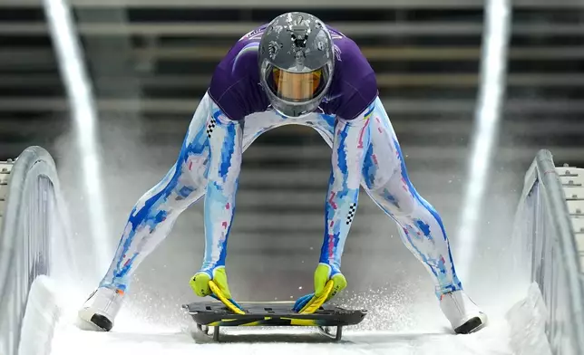 Ukraine's Vladyslav Heraskevych arrives at the finish during a men's skeleton training session at the 2026 Winter Olympics, in Cortina d'Ampezzo, Italy, Monday, Feb. 9, 2026. (AP Photo/Aijaz Rahi)