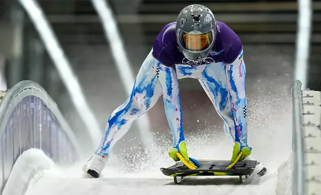 Ukraine's Vladyslav Heraskevych arrives at the finish during a men's skeleton training session at the 2026 Winter Olympics, in Cortina d'Ampezzo, Italy, Monday, Feb. 9, 2026. (AP Photo/Aijaz Rahi)