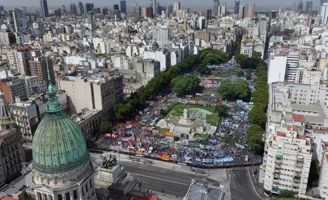 Unions and opposition supporters protest a labor reform bill proposed by President Javier Milei's government outside Congress in Buenos Aires, Argentina, Wednesday, Feb. 11, 2026. (AP Photo/Rodrigo Abd)