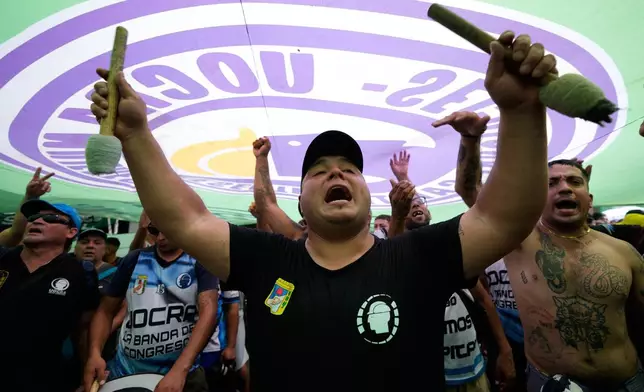 Protesters chant during a march by trade unions and opposition groups against a labor reform bill proposed by President Javier Milei's government in Buenos Aires, Argentina, Wednesday, Feb. 11, 2026.(AP Photo/Gustavo Garello)