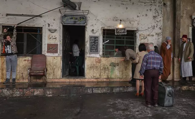 A television crew films an episode of the TV series "Al-Souriyoun al-Aada" ("The Syrian Enemies"), based on a novel of the same name that was banned under Bashar Assad, along a transformed street in central Aleppo, Syria, Friday, Feb. 13, 2026.(AP Photo/Ghaith Alsayed)