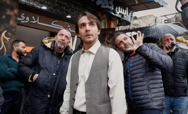 Director Al Layth Hajjo, center right, gives instructions to actor Wissam Rida, center, while filming an episode of the TV series "Al-Souriyoun al-Aada" ("The Syrian Enemies"), based on a novel of the same name that was banned under Bashar Assad, in central Aleppo, Syria, Friday, Feb. 13, 2026. (AP Photo/Omar Sanadiki)