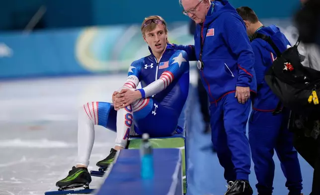 Jordan Stolz of the U.S. and coach Bob Corby talk after the men's 1,000 meters speedskating race at the 2026 Winter Olympics, in Milan, Italy, Wednesday, Feb. 11, 2026. (AP Photo/Luca Bruno)