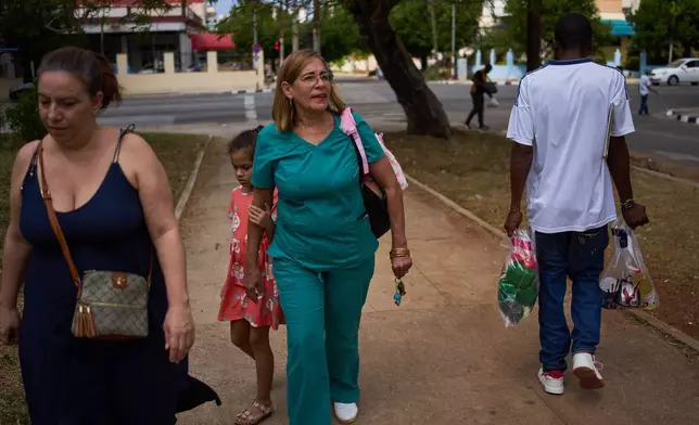 State-run bodega manager Roberto Roman carries bags of donated Mexican humanitarian assistance to be delivered to a family, in Havana, Cuba, Thursday, Feb. 19, 2026. (AP Photo/Ramon Espinosa)