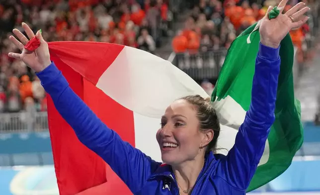 Gold medallist Francesca Lollobrigida of Italy celebrates with the Italian flag after the women's 3,000 meters speedskating race at the 2026 Winter Olympics, in Milan, Italy, Saturday, Feb. 7, 2026. (AP Photo/Christophe Ena)