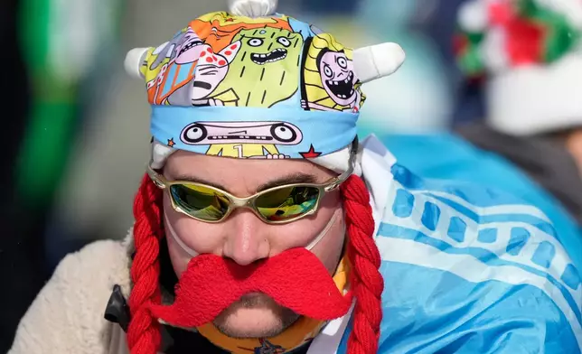 A fan attends the men's 15-kilometer mass start biathlon race at the 2026 Winter Olympics in Anterselva, Italy, Friday, Feb. 20, 2026. (AP Photo/Mosa'ab Elshamy)