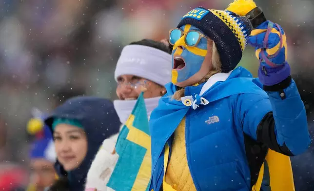 A fan of Sweden reacts as Sweden wins bronze in the men's 4x7.5-kilometer relay biathlon race at the 2026 Winter Olympics in Anterselva, Italy, Tuesday, Feb. 17, 2026. (AP Photo/Mosa'ab Elshamy)