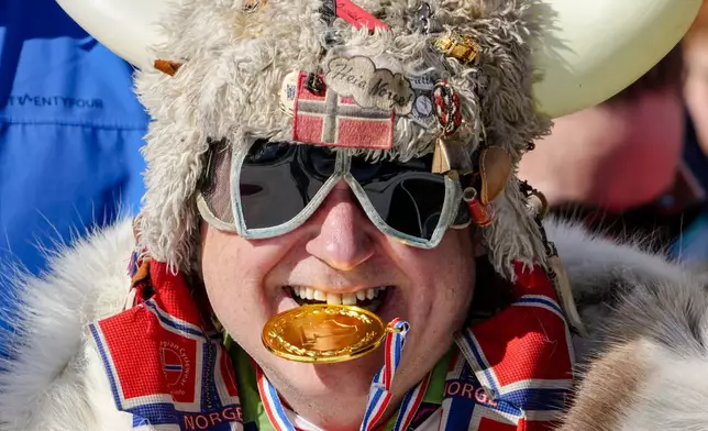 A Norway fan poses on the stands during the cross-country skiing men's and women's team sprint free events at the 2026 Winter Olympics, in Tesero, Italy, Wednesday, Feb. 18, 2026. (AP Photo/Matthias Schrader)