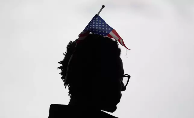 A fan watches the ice dancing free skate in figure skating at the 2026 Winter Olympics, in Milan, Italy, Wednesday, Feb. 11, 2026. (AP Photo/Francisco Seco)