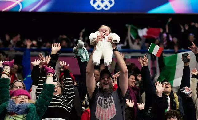 Fans cheer before the figure skating ice dance team event at the 2026 Winter Olympics, in Milan, Italy, Saturday, Feb. 7, 2026. (AP Photo/Natacha Pisarenko)