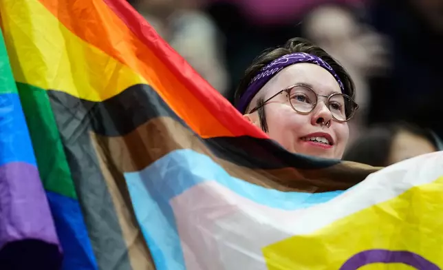 Fans cheer before the women's short program figure skating at the 2026 Winter Olympics, in Milan, Italy, Tuesday, Feb. 17, 2026. (AP Photo/Natacha Pisarenko)