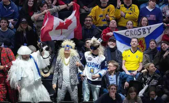 Fans wait for the start of a men's ice hockey semifinal game between Canada and Finland at the 2026 Winter Olympics in Milan, Italy, Friday, Feb. 20, 2026. (AP Photo/Carolyn Kaster)