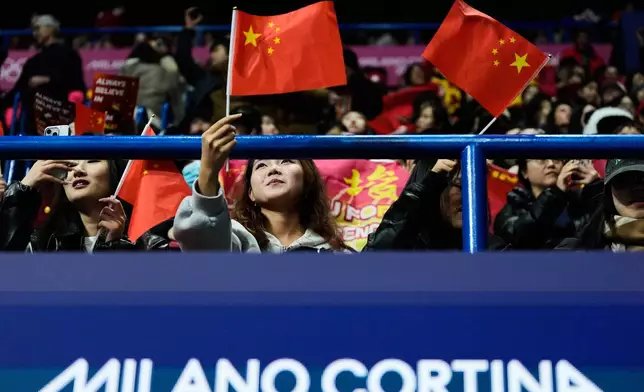 Fans wait for the short track speed skating men's 500m to start at the 2026 Winter Olympics, in Milan, Italy, Wednesday, Feb. 18, 2026. (AP Photo/Ashley Landis)