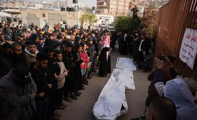 Palestinians perform funeral prayers over the bodies of Hamas militants who were killed in an Israeli military strike, at Nasser Hospital in Khan Younis, Gaza, Sunday, Feb. 15, 2026. (AP Photo/Abdel Kareem Hana)