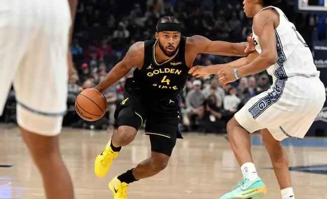 in the first half of an NBA basketball game Wednesday, Golden State Warriors guard Moses Moody (4) handles the ball against Memphis Grizzlies forward Jaylen Wells (0) Feb. 25, 2026, in Memphis, Tenn. (AP Photo/Brandon Dill)