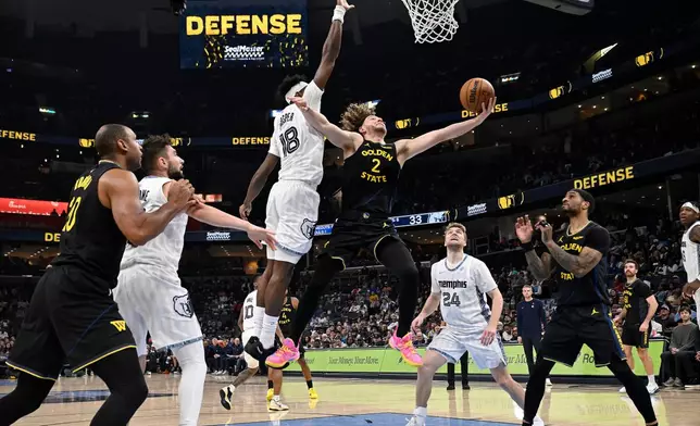 Golden State Warriors guard Brandin Podziemski (2) shoots against Memphis Grizzlies forward Olivier-Maxence Prosper (18) in the first half of an NBA basketball game, Wednesday, Feb. 25, 2026, in Memphis, Tenn. (AP Photo/Brandon Dill)