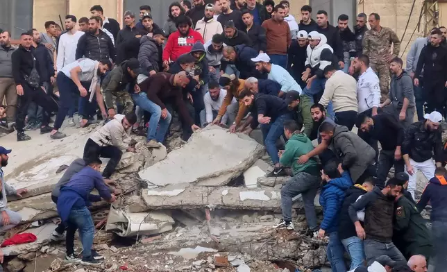 Rescue workers and residents search for survivors in the rubble of a building that collapsed in the northern city of Tripoli, Lebanon, Sunday, Feb. 8, 2026. (AP Photo)
