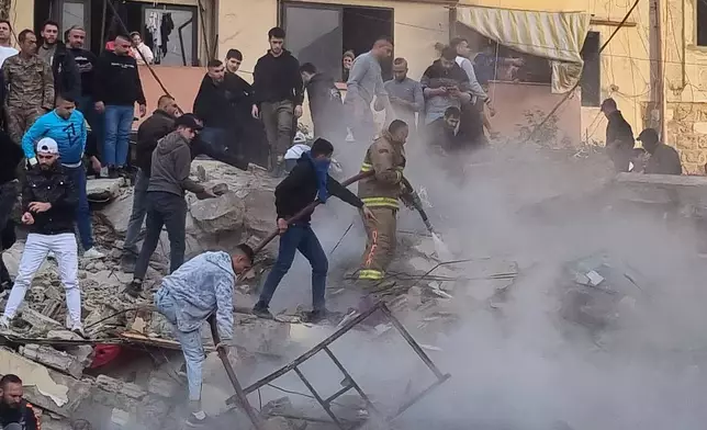 Rescue workers and residents search for survivors in the rubble of a building that collapsed in the northern city of Tripoli, Lebanon, Sunday, Feb. 8, 2026. (AP Photo)