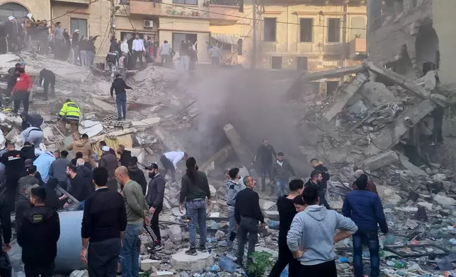 Rescue workers and residents search for survivors in the rubble of a building that collapsed in the northern city of Tripoli, Lebanon, Sunday, Feb. 8, 2026. (AP Photo)