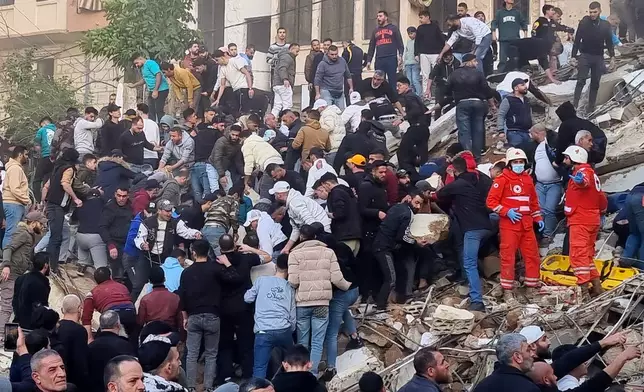 Rescue workers and residents search for survivors in the rubble of a building that collapsed in the northern city of Tripoli, Lebanon, Sunday, Feb. 8, 2026. (AP Photo)