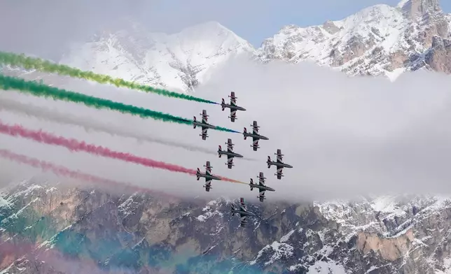 The Italian Frecce Tricolori acrobatic squad flies above during the medal ceremony of an alpine ski, women's super-G race, at the 2026 Winter Olympics, in Cortina d'Ampezzo, Italy, Thursday, Feb. 12, 2026.(AP Photo/Robert F. Bukaty)