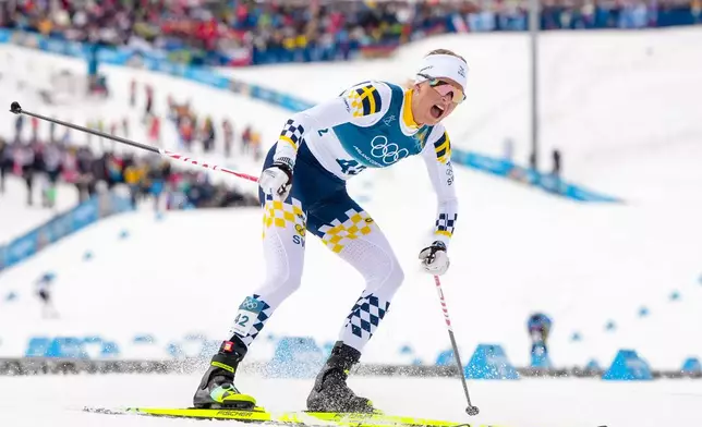 Frida Karlsson, of Sweden, reacts after crossing the finish line in the cross country skiing women's 10km interval start free at the 2026 Winter Olympics, in Tesero, Italy, Thursday, Feb. 12, 2026. (AP Photo/Kirsty Wigglesworth)