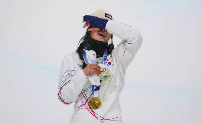Gold medalist South Korea's Choi Ga-on reacts on the podium after winning the women's snowboarding halfpipe finals at the 2026 Winter Olympics, in Livigno, Italy, Thursday, Feb. 12, 2026. (AP Photo/Lindsey Wasson)
