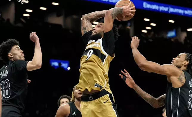 Washington Wizards forward Justin Champagnie (9) dunks during the second half of an NBA basketball game against the Brooklyn Nets, Saturday, Feb. 7, 2026, in New York. (AP Photo/Yuki Iwamura)