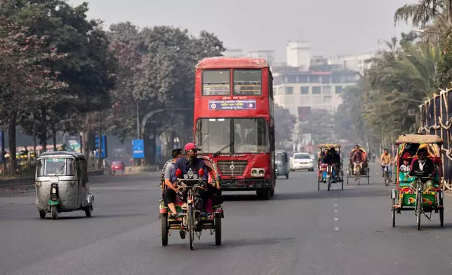 People ride on three wheelers on a street ahead of Thursday's national parliamentary election, in Dhaka, Bangladesh, Wednesday, Feb. 11, 2026. (AP Photo/Anupam Nath)