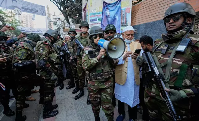 An army official announces to the voters to maintain discipline in a polling station during national parliamentary election in Dhaka, Bangladesh, Thursday, Feb. 12, 2026. (AP Photo/Anupam Nath)