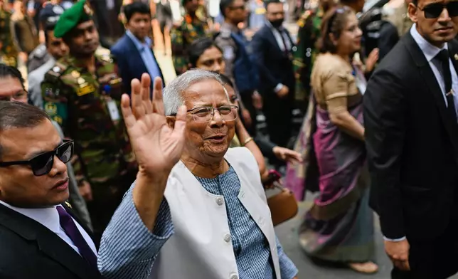 Chief Adviser of Bangladesh Muhammad Yunus waves after casting his vote during the national parliamentary elections in Dhaka, Bangladesh, Thursday, Feb. 12, 2026. (AP Photo/Mahmud Hossain Opu)