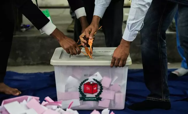Bangladeshi polling officials open a ballot box for counting after the voting of national parliamentary election ended at a polling station in Dhaka, Bangladesh, Thursday, Feb. 12, 2026. (AP Photo/Anupam Nath)