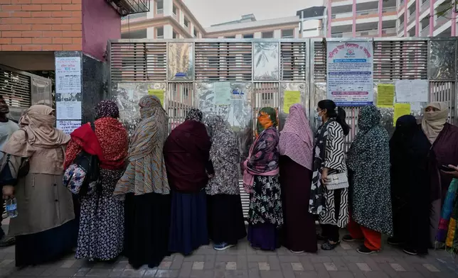 Bangladeshi women stand in queue to cast their votes in a polling station during national parliamentary election in Dhaka, Bangladesh, Thursday, Feb. 12, 2026. (AP Photo/Anupam Nath)